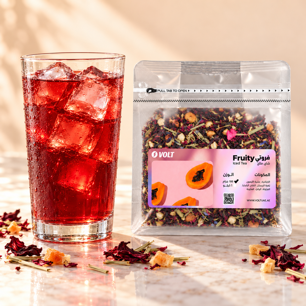 Glass of Fruity hibiscus iced tea over ice with VOLT pouch