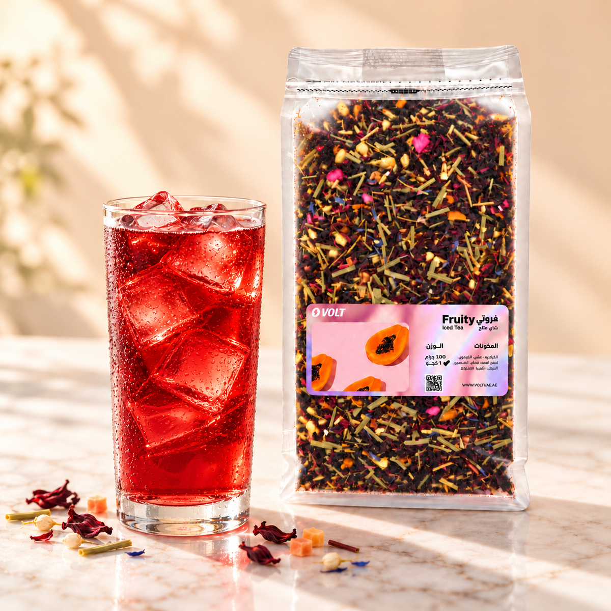 Glass of Fruity hibiscus iced tea over ice with VOLT pouch